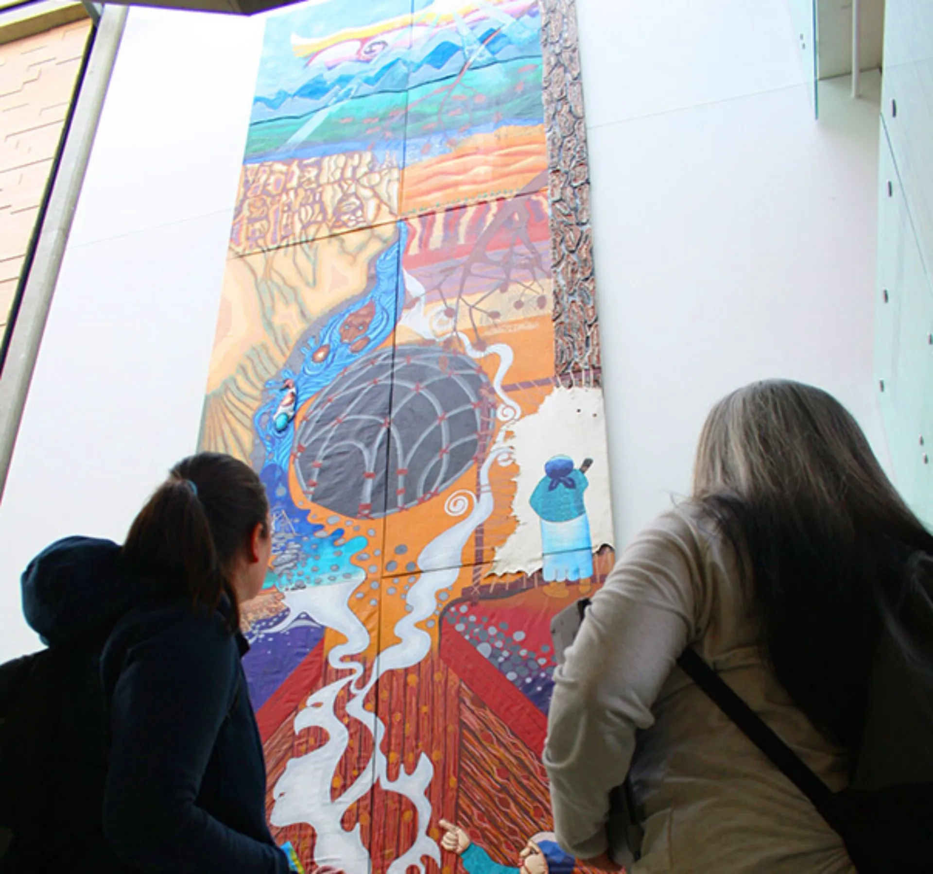 Two girls looking at art 604x566